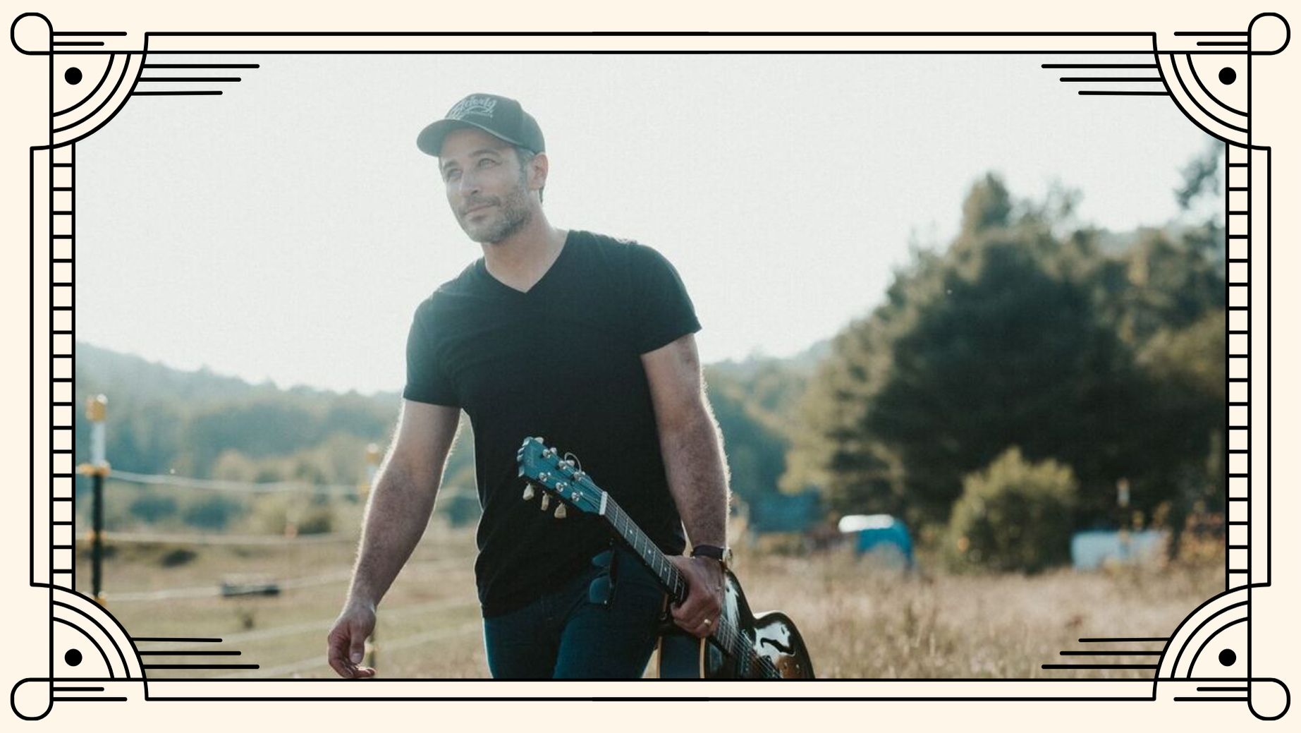 Musician Joshua Davis walking in a field.